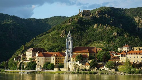 Evening light over Dürnstein with dramatic landscape and river, Danube cycle path, Wachau World