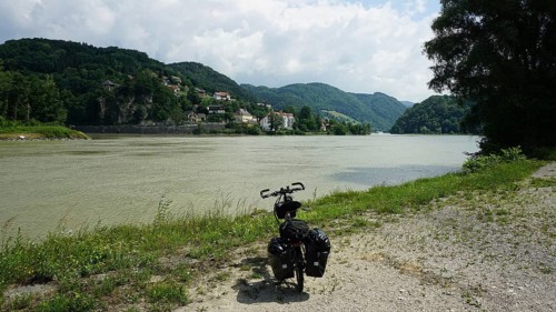 Cycling on the banks of the Danube with rolling hills and clouds, cycling on the long-distance