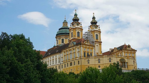 Baroque monastery in Melk surrounded by trees and sky, Melk, Austria