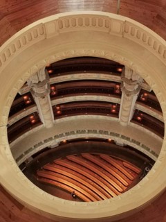 View of a round, elegant interior with wooden floors and rows of seats, Dresden