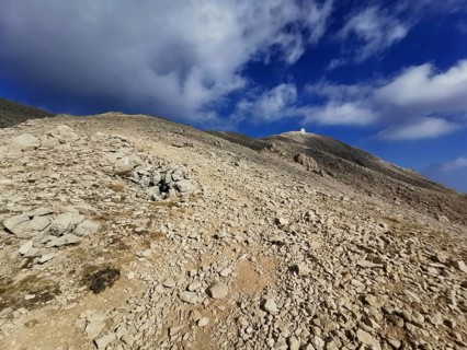 Rocky path leads to the summit of Tahtali Dagi under a partly cloudy sky, climbing Tahtali Dagi,