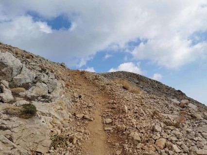 A rocky path snakes up Tahtali Dagi to the cloudy sky, climbing Tahtali Dagi, Lycia, Turkey