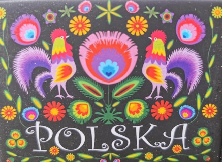 Colourful traditional Polish folk art with roosters and flowers on a black background and the