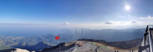 Panorama at the summit of Tahtali Dagi, extensive mountain landscape with a Turkish flag and clear