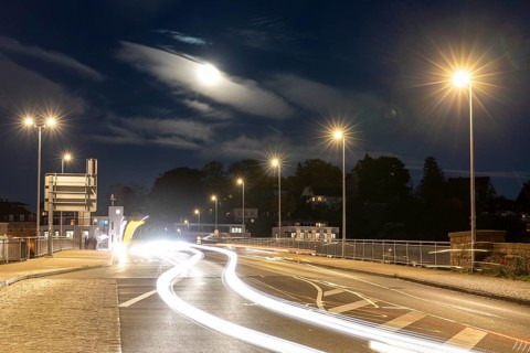 Night scene at the old Elbe bridge with traffic, lanterns and full moon, Meissen, Saxony, Germany