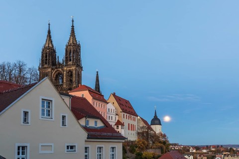 Full moon on Burgberg and over the old town at blue hour in Meissen, Saxony, Germany