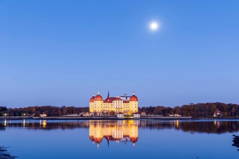 Moritzburg hunting lodge with full moon early in the morning, Meissen district, Saxony, Germany