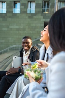 Diverse group of friends or colleagues enjoying a happy moment together outdoors, laughing and
