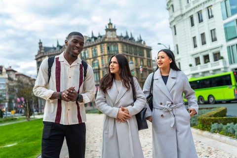 Diverse friends enjoying a casual walk through an urban park, engaging in conversation while