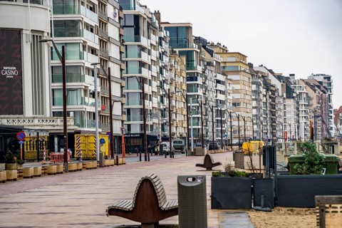 An urban promenade with modern high-rise buildings by the sea under cloudy sky, Zeedijk-Knokke,