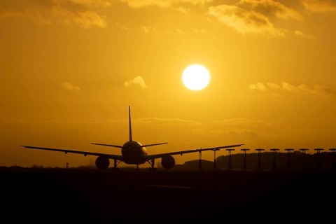 Boeing 777 A7-BFL commercial jet aircraft of Qatar cargo waiting to take off silhouette at sunset