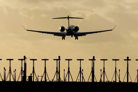 Gulfstream executive business jet aircraft in flight on approach to land at sunset at London
