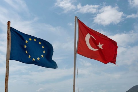 Alanya, Turkey. April 8th 2021 Tattered Turkish and European Flags flying on the beach in Alanya on