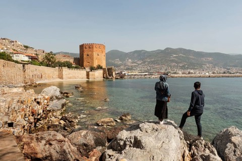 Alanya, Turkey. April 7th 2021 Turkish tourists enjoy the view of the ancient walls of Alanya
