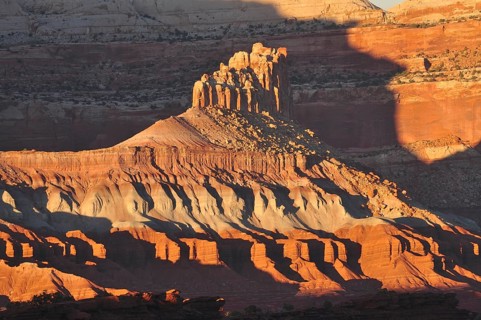 Rock formation in evening light with dramatic shadows in a barren desert landscape, Capitol Reef