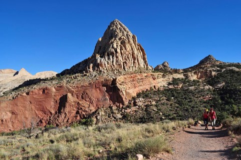 Proud rock formation rising above migrating people, Capitol Reef National Park, Utha, USA