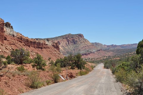 Gravel road through rolling red rock landscape, ideal landscape, Capitol Reef National Park, Utha,