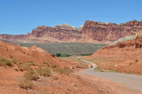 Extensive road through a landscape of red rocks and clear blue sky, Capitol Reef National Park,