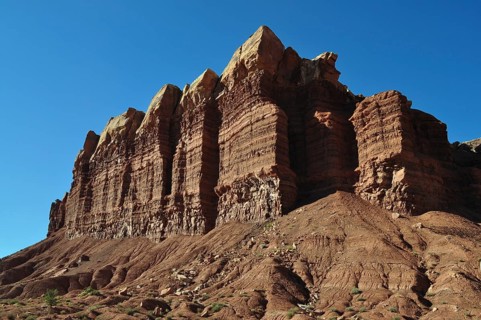 Distinctive rock structure with distinctive shapes against a deep blue sky characterized by