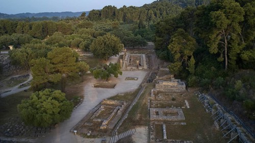 Soft morning light, Temple of Hera, ruins and thick forests in hilly surroundings, drone shot,