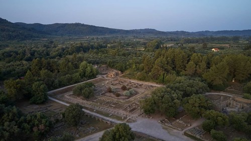 Leonidaion, archaeological ruins in landscape with trees and mountains in the background, drone