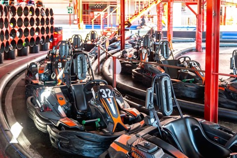 Go karts lining up on a designated track, preparing for a recreational racing session at an