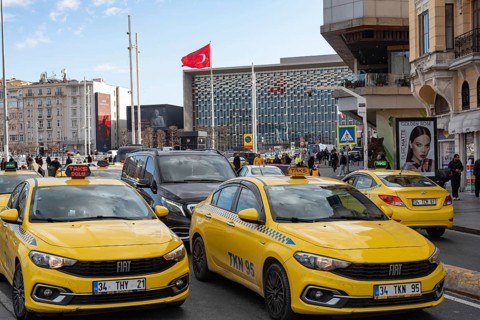 Istanbul, Turkey. January 3rd 2025. Yellow Turkish taxi cabs in busy traffic around Taksim square,