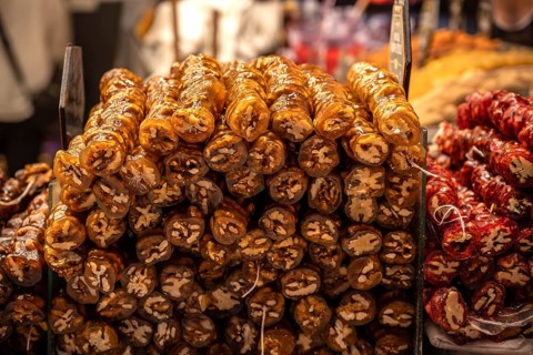 A colorful display of Cevizli Sucuk-Sweet Turkish Rolls made from Grape Molasses and Walnuts, for