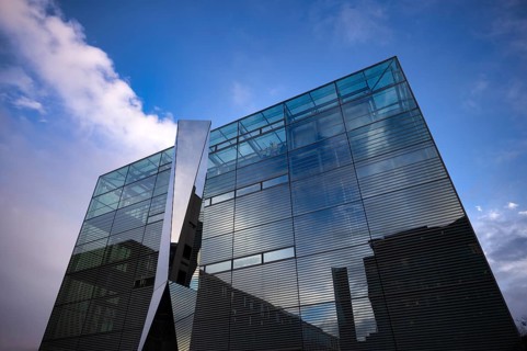Glass and polylite sculpture by Carsten Nicola in front of the art museum, cube, glass cube,