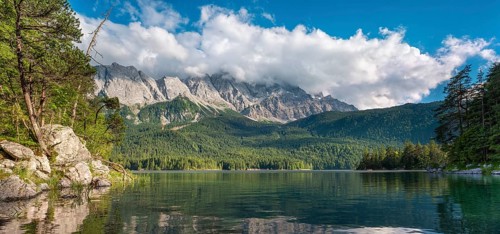 View over Lake Eibsee lake, the Wetterstein Mountains with the Zugspitze in the background, clouds