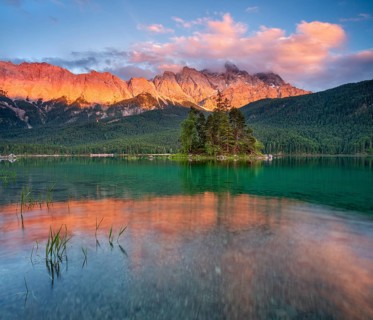 Evening atmosphere on Lake Eibsee lake with alpine glow, in the back the Wetterstein Mountains with