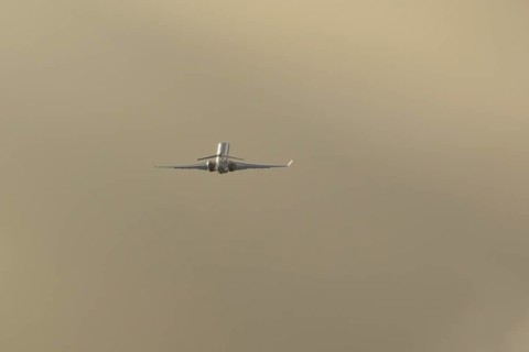 Gulfstream executive business jet aircraft in flight at sunset at London Stansted airport, Essex,
