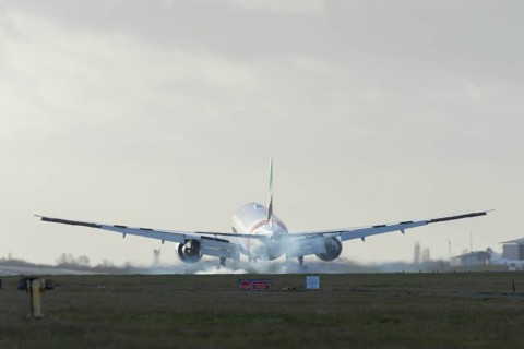Boeing 777 commercial passenger airliner jet aircraft of Emirates airways landing on the runway at