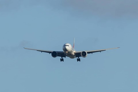 Boeing 777 commercial passenger airliner jet aircraft of Emirates airways in flight on approach to