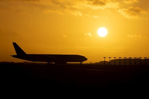 Boeing 777 A7-BFL commercial jet aircraft of Qatar cargo waiting to take off silhouette at sunset