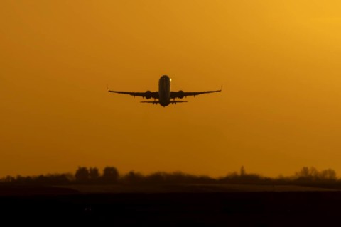 Airbus commercial passenger airliner jet aircraft taking off in flight at sunset at London Stansted