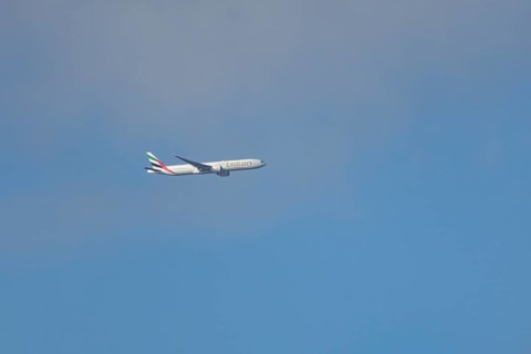 Boeing 777 commercial passenger airliner jet aircraft of Emirates airways in flight at London