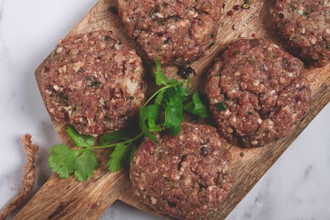 Raw cutlets, minced meat, on a chopping board, homemade, top view, no people
