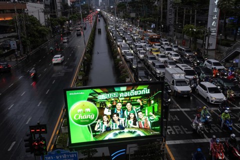 Bangkok, Thailand. March 26th 2025. An illuminated advertisement for Chang Beer in the busy