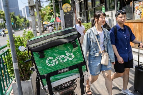 Bangkok, Thailand. March 25th 2025. Grab food delivery motorcycles parked in the busy streets of