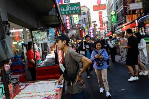 Bangkok, Thailand. February 18th 2025. A local man stops to buy lottery tickets along a busy