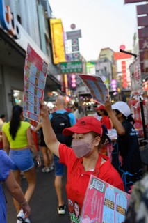 Bangkok, Thailand. February 18th 2025. Restaurant waitresses wave menus to attract customers in