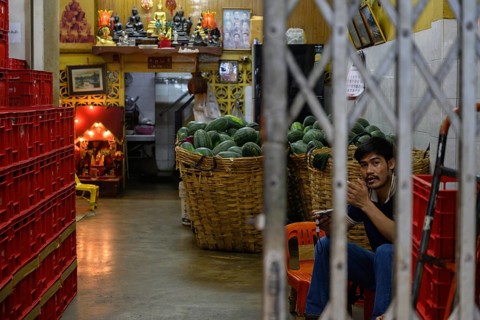 Bangkok, Thailand. March 2rd 2025. A Thai worker inside Pak Khlong Talat-Bangkok Flower Market, a