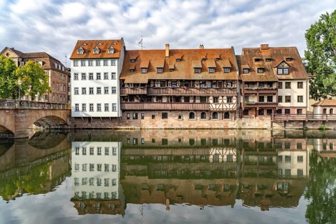 Houses in the old town are reflected in Pegnitz, Nuremberg, Bavaria, Germany