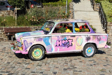 Colourfully painted and planted Trabant car on the old market in Hohenstein-Ernstthal, Saxony,
