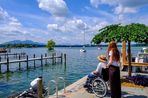 Strollers with wheelchair, Fraueninsel, Chiemsee, Chiemgau, Upper Bavaria, Bavaria, Germany