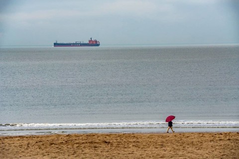 Winter break, on Zeedijk-Knokke, beach promenade in Knokke-Heist, beach walkers with umbrella when