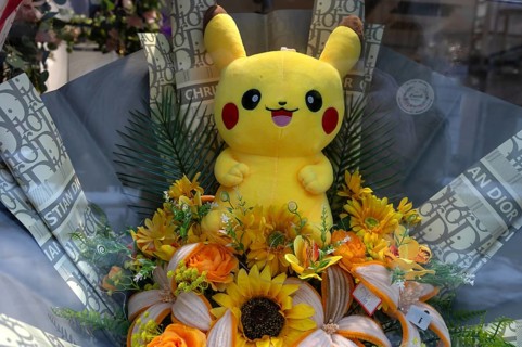 Yellow Pikatchu, Pokémon, fictional character of a video game in a shop window, Bavaria, Germany