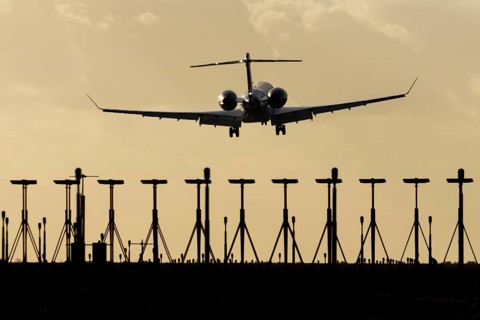 Gulfstream executive business jet aircraft in flight on approach to land at sunset at London