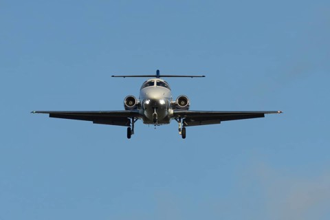 Cessna Citation small executive business jet aircraft in flight on approach to land at London